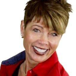 Photo of Dee Mefford, woman with short hair in red shirt