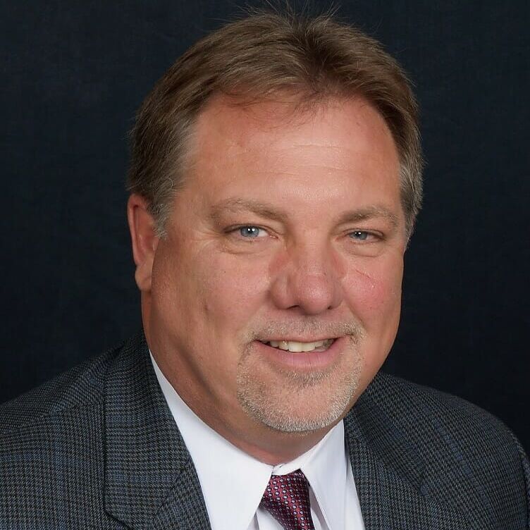 Photo of Tim Lowe, Man in gray suit & tie